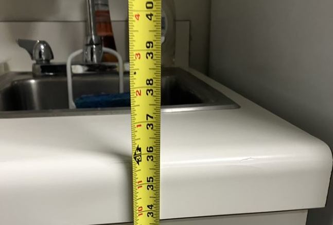 A measuring tape on a sink
